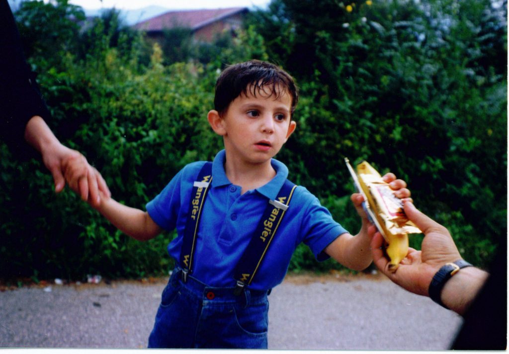 Srebrenica massacre - A Bosnian boy receives food aid.