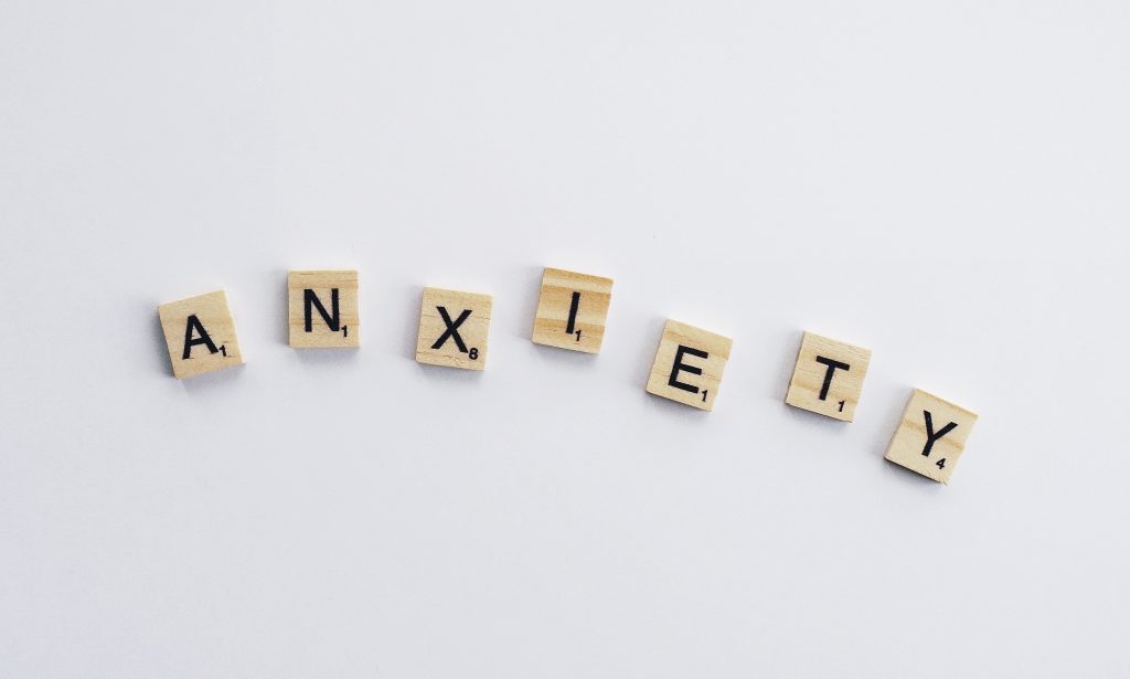 Anxiety spelled out in tile letters on white background