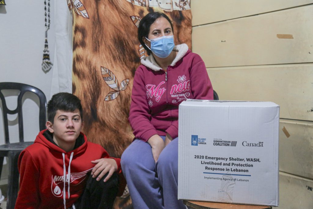 Hanaa with her son in Lebanon receiving hygiene kit from Islamic Relief Canada and Humanitarian Coalition