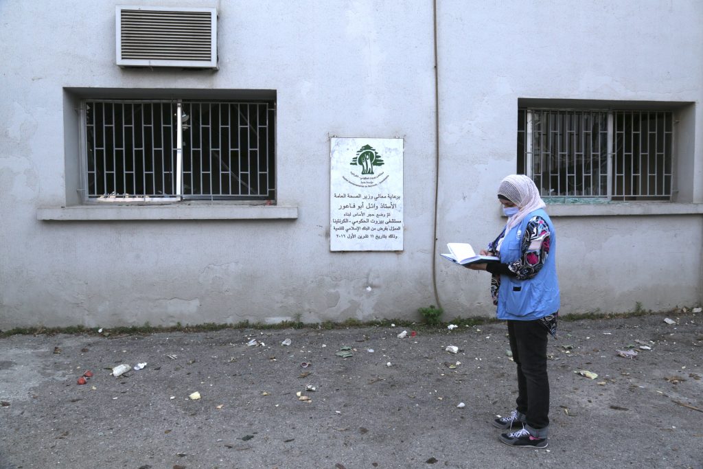 Islamic Relief staff - Woman standing with a clipboard during Lebanon Blast assessment for Humanitarian Coalition.