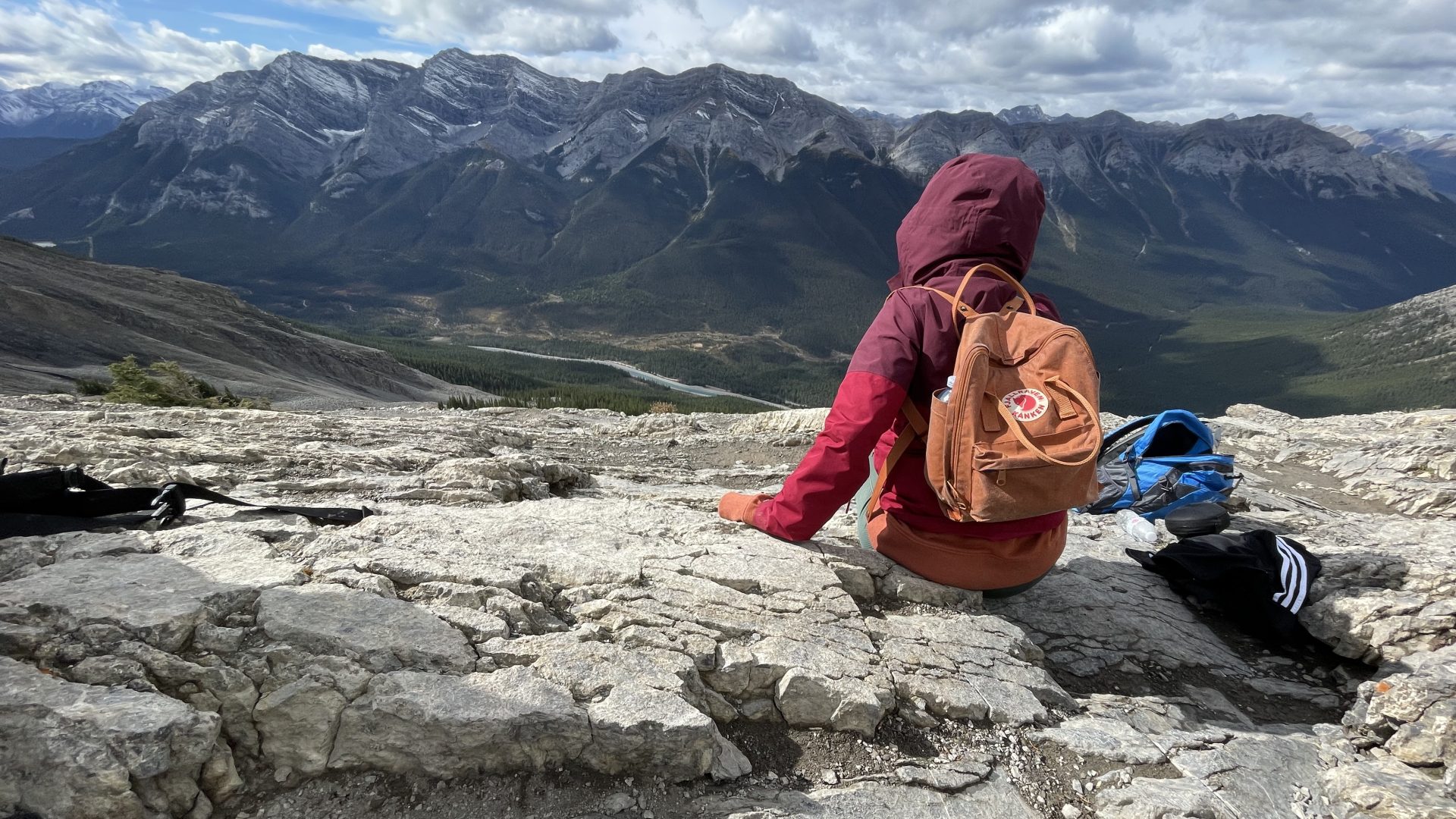 Woman sits looking out at view in Banff on Islamic Relief Hiking Challenge